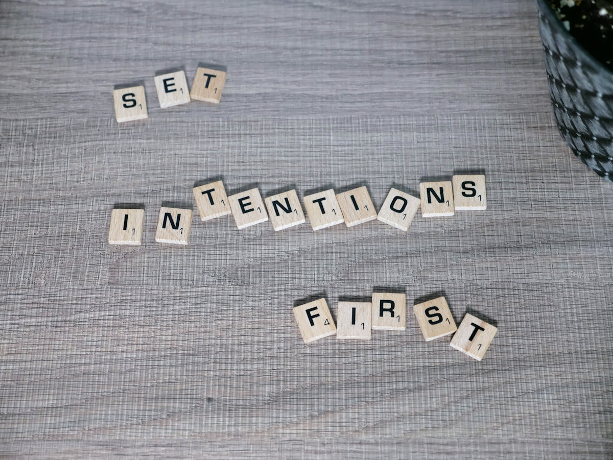 scrabble tiles spelling out the words set in intentions first