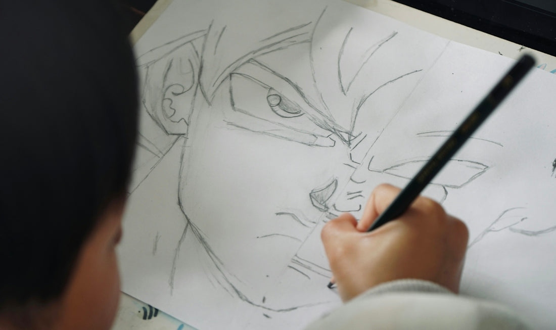 Child drawing anime character with pencil on paper